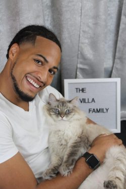 A man holding a cat in his arms.